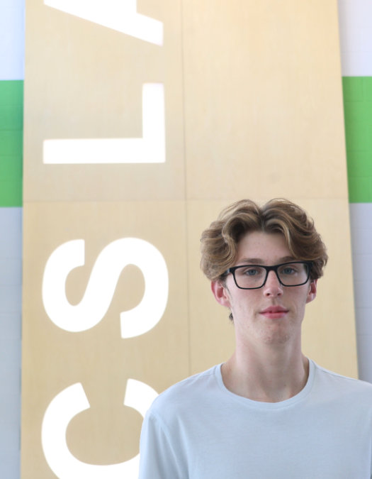 High School Senior standing in front of CSLA sign