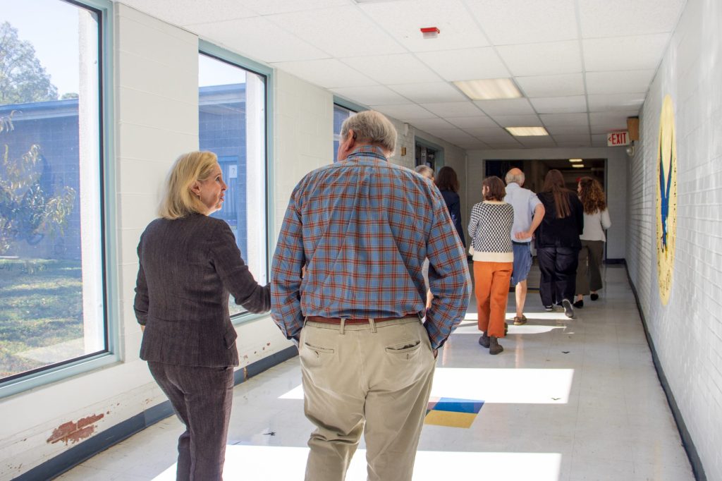People walk down a hallway