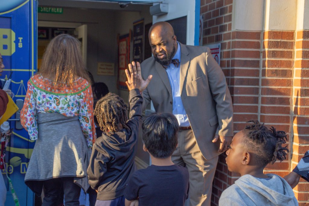 Marques Stewart gives a student a high-five