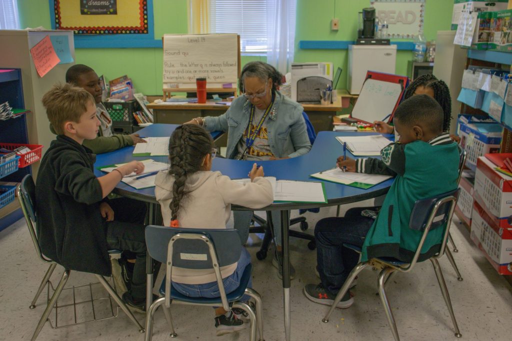 A teacher works with students