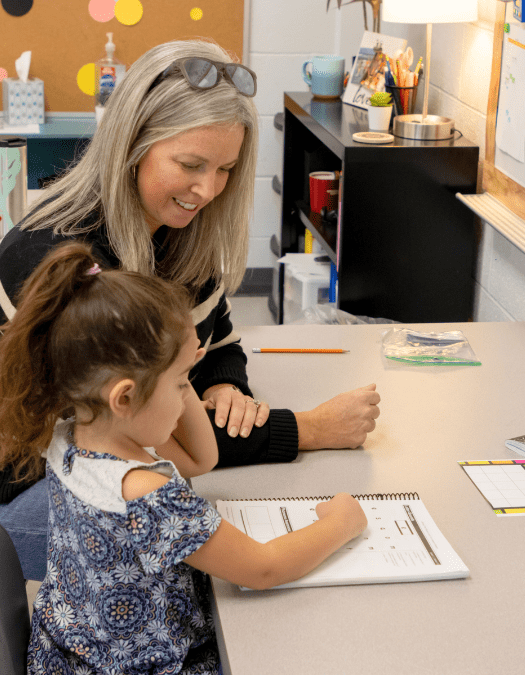 A teacher helps a student