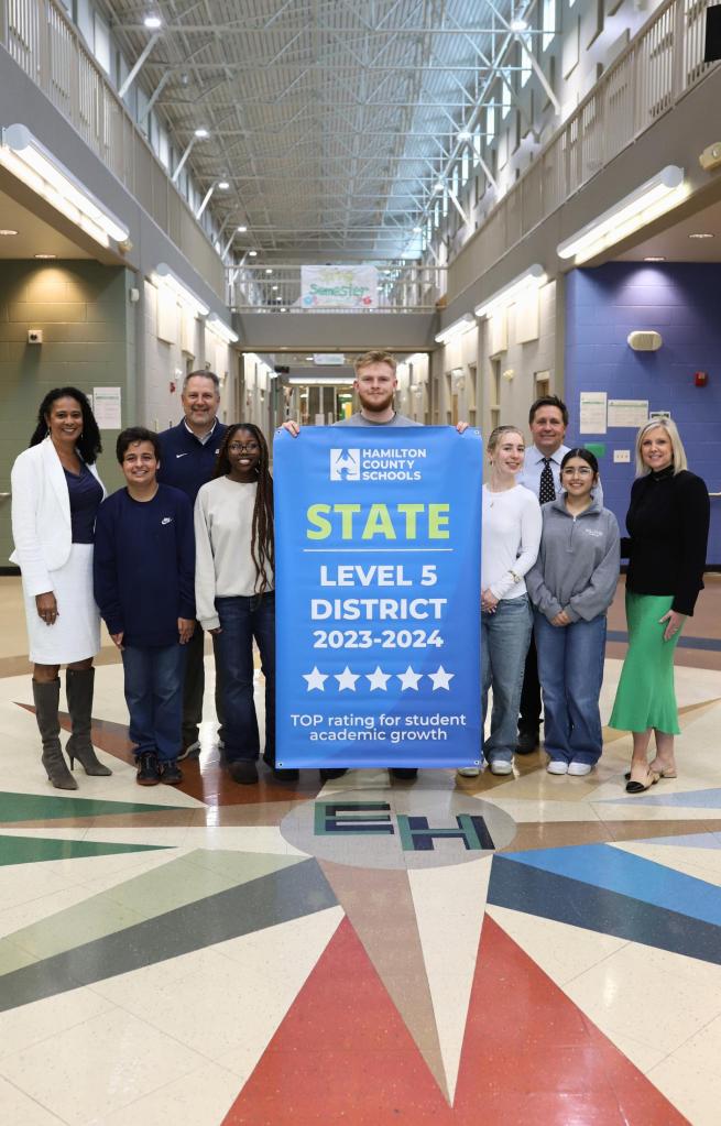 NEWSROOM COVER - Storybook Trail-5 Students pose for a banner presentation photo at EHHS