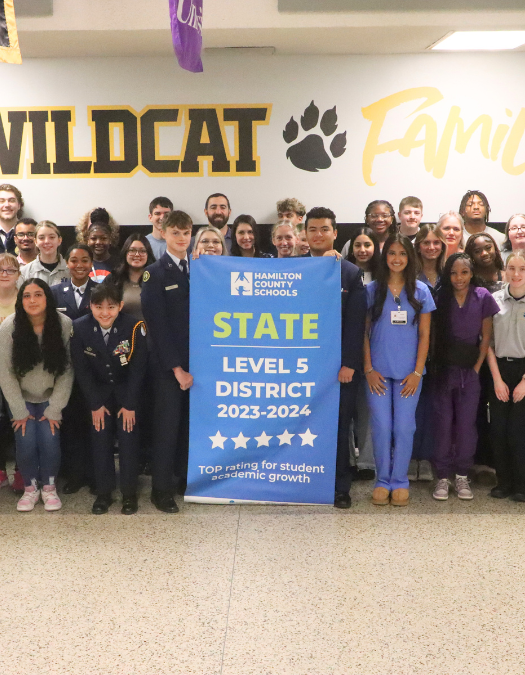 Students pose for a banner presentation photo