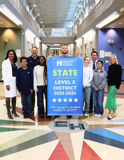 Students pose for a banner presentation photo at EHHS