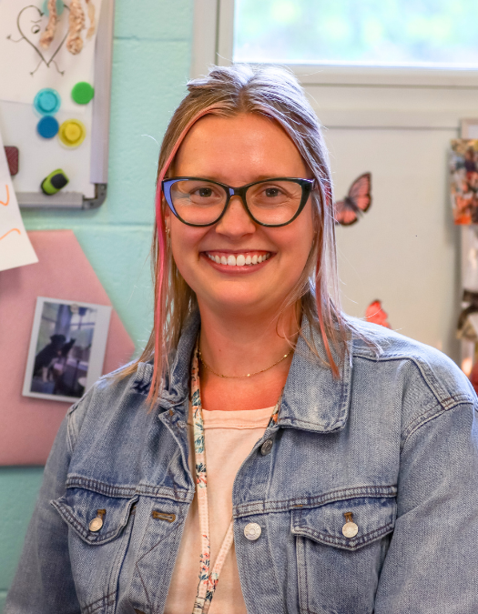 A teacher poses for a photo