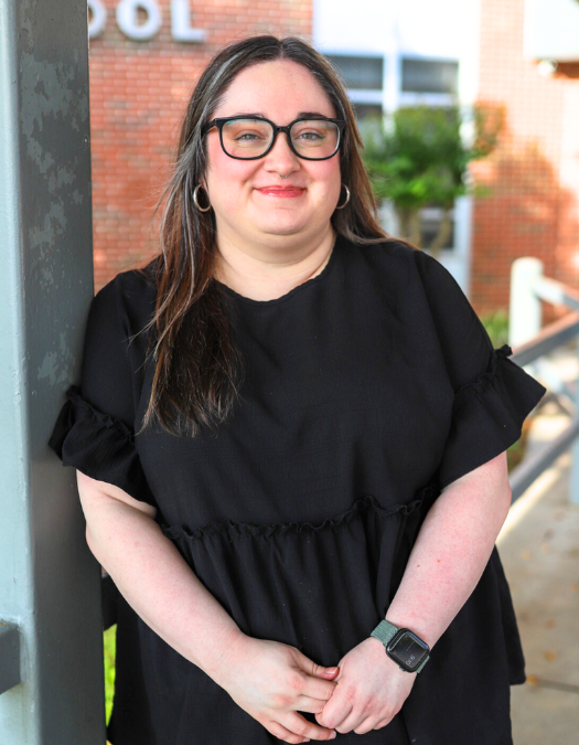 A teacher poses for a photo