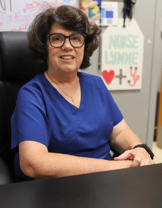 A nurse poses for a photo