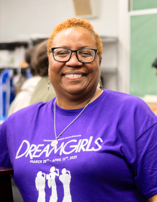 A teacher poses for a photo