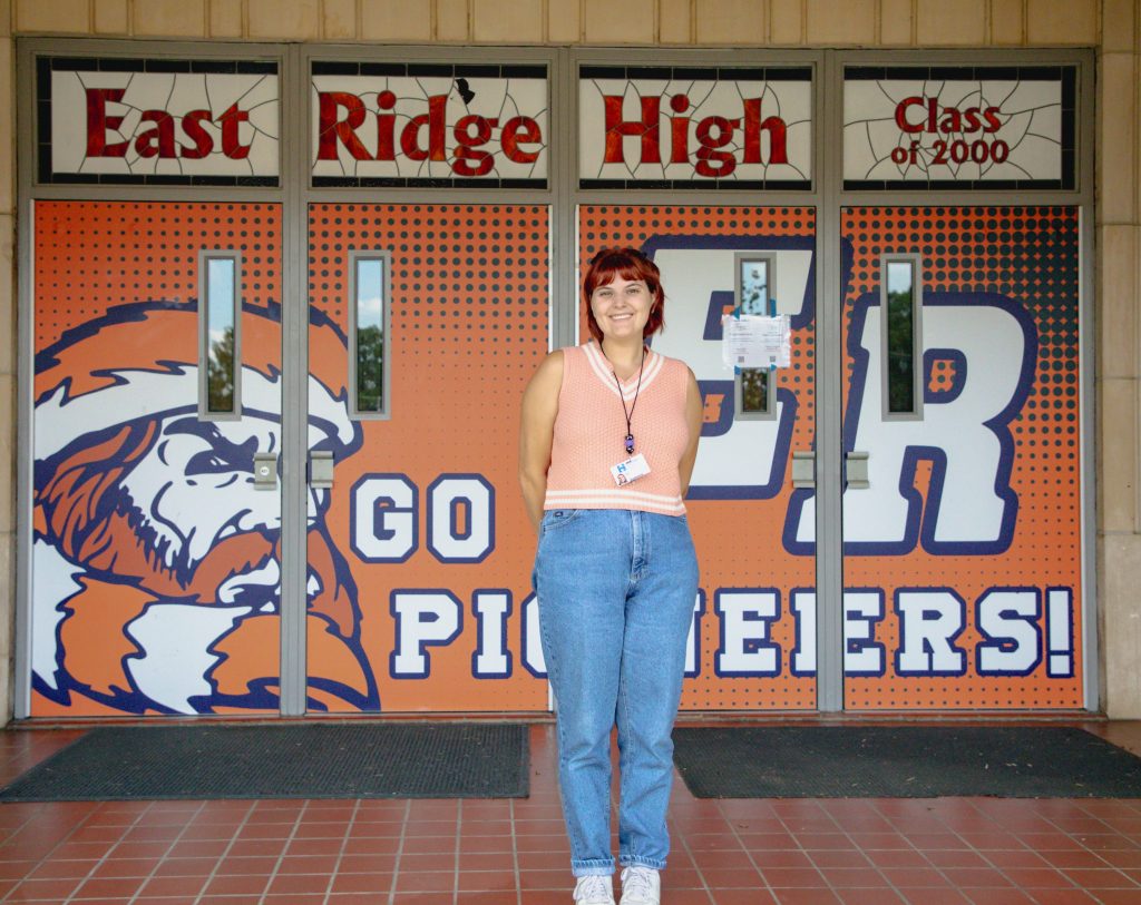 0D5A2073-2 teacher in front of east ridge high front doors