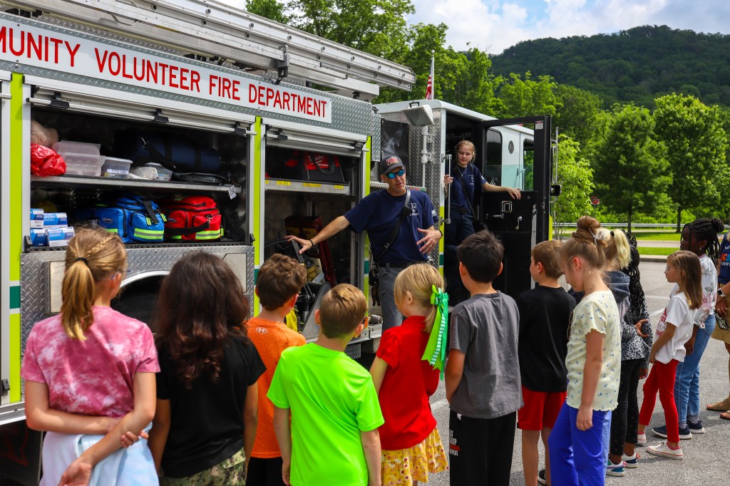 Students listen to a fire fighter talk
