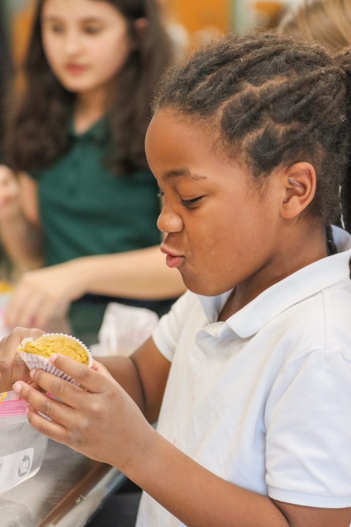 A student holds a muffin