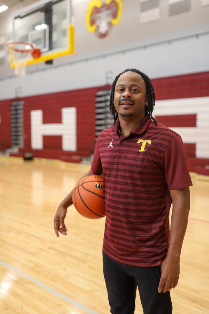 A coach poses for a photo