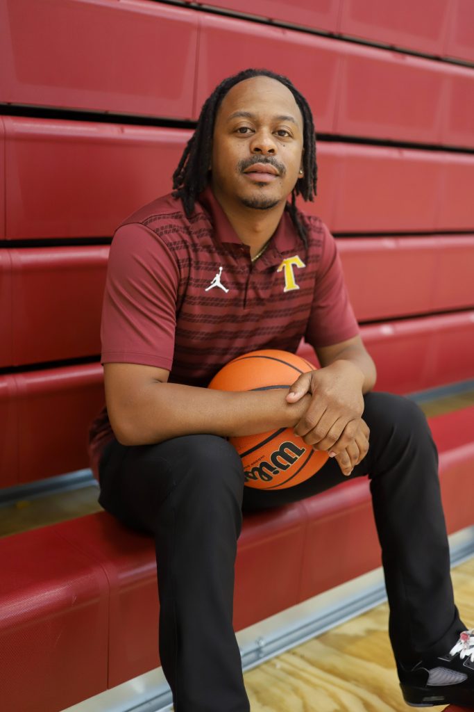 A coach poses for a photo