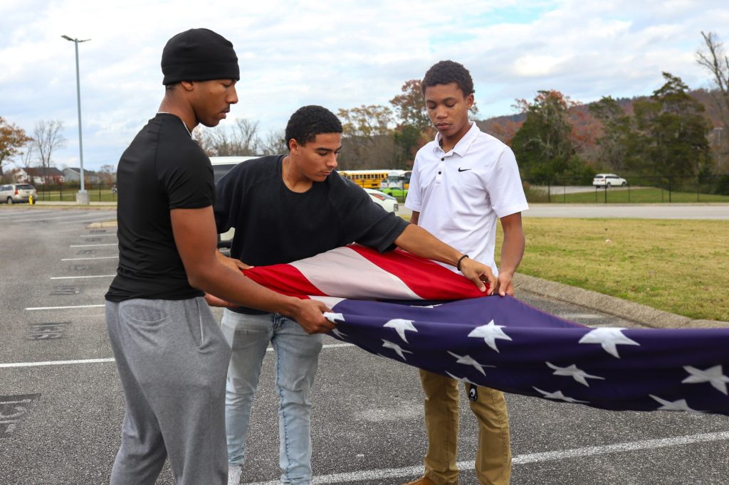 FLAG students folding American flag