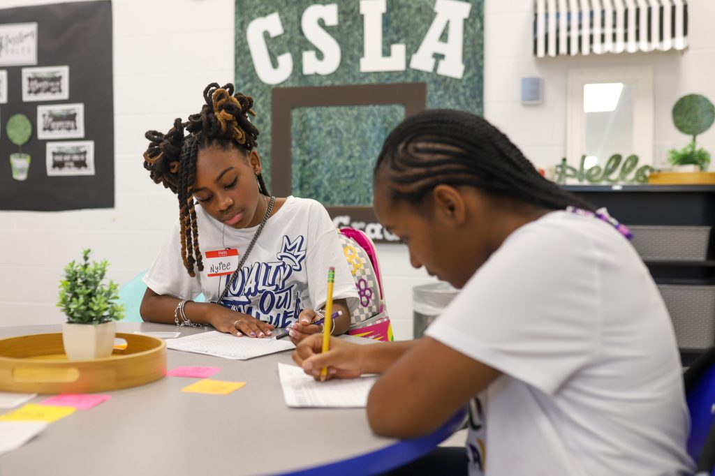 FirstDayEdited-14 middle school kids at CSLA writing at table