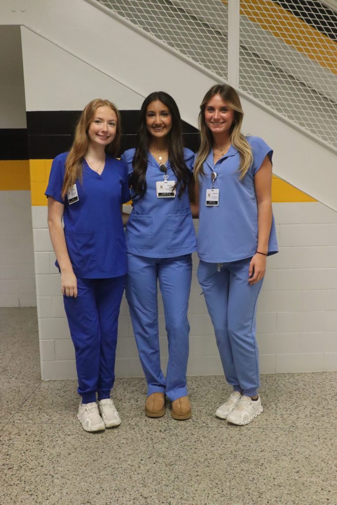 IMG_1934 Students pose for a photo in scrubs