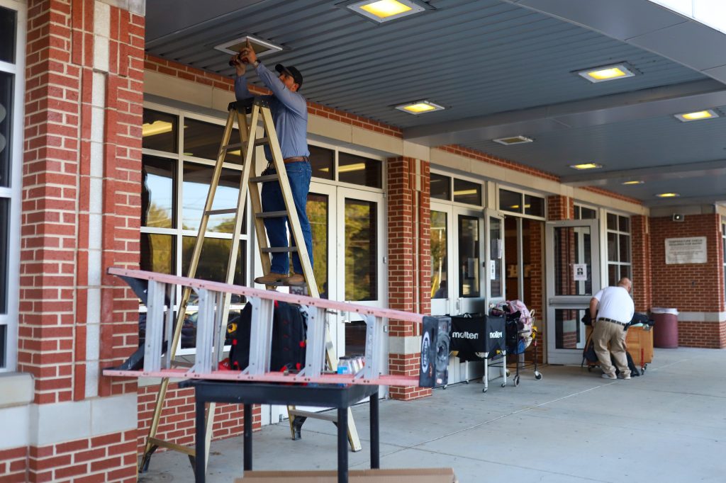 MAINT-5 A man fixes a light