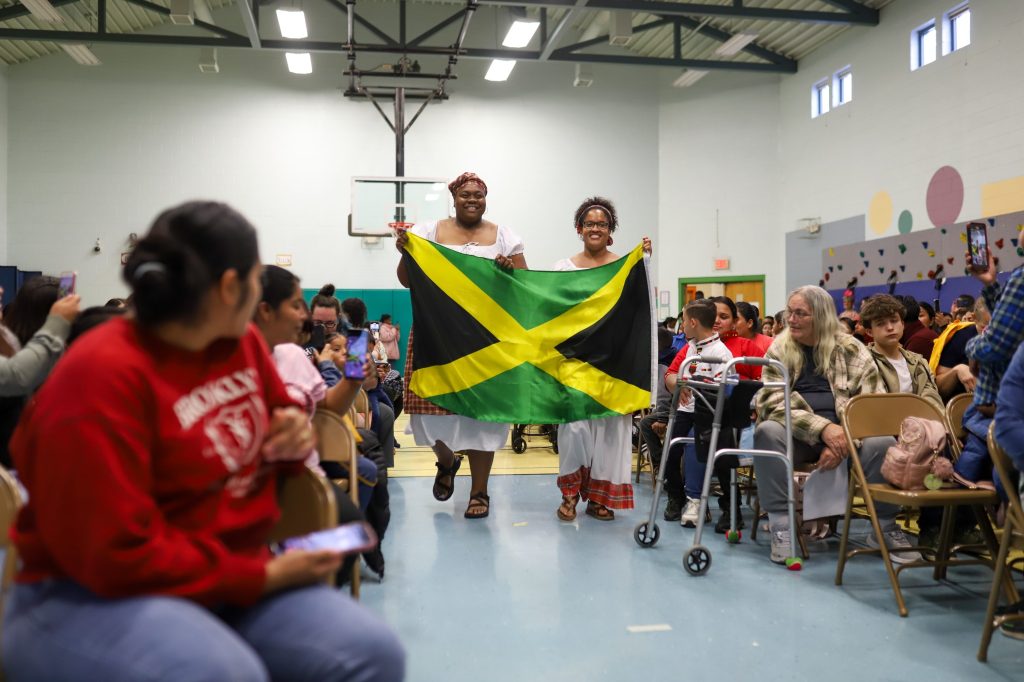 MulticulturalNight-26 Two teachers carry a flag