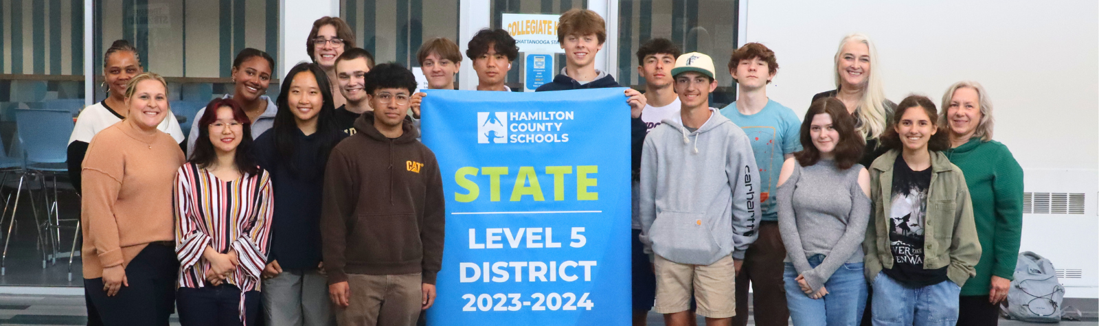 Students pose for a banner presentation photo