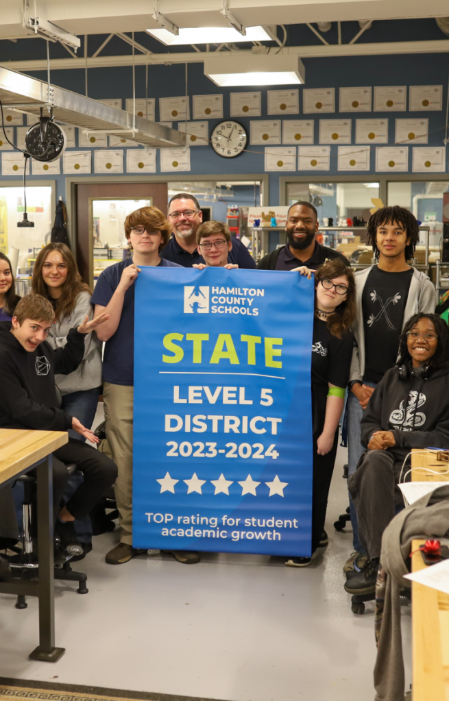 NEWSROOM COVER - Storybook Trail-16 Students pose for a banner presentation photo