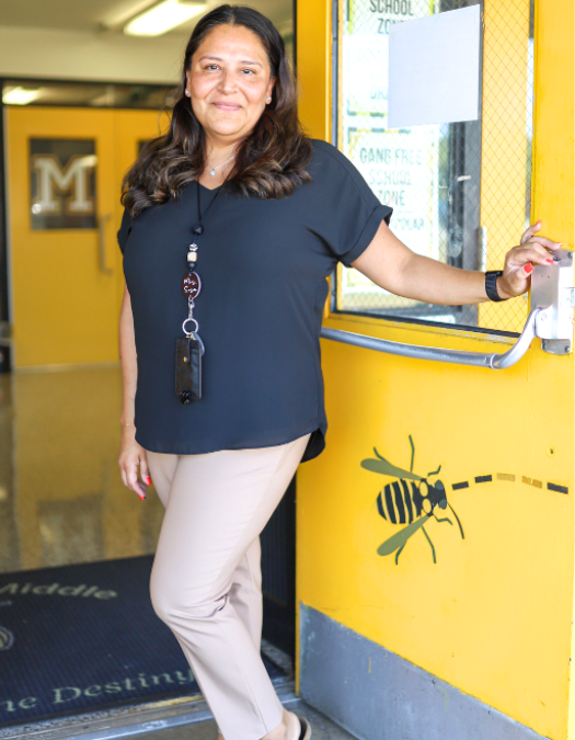 teacher holding open door of orchard knob middle school