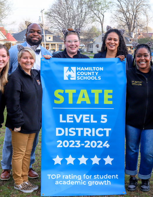 Students pose for a banner presentation photo