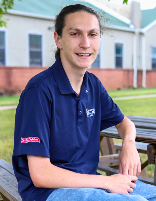 Graduate man in little debbie shirt