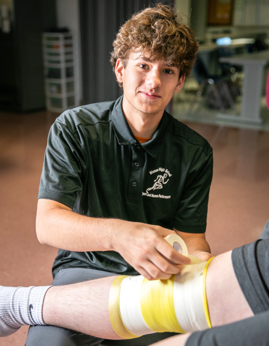 students practice wrapping leg