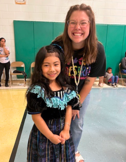 teacher with elementary student dressed up for hispanic heritage month event at east lake elementary