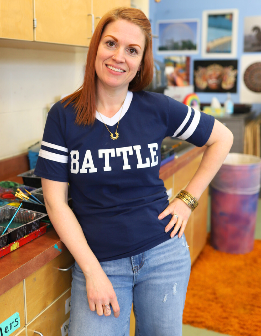 An art teacher poses for a photo