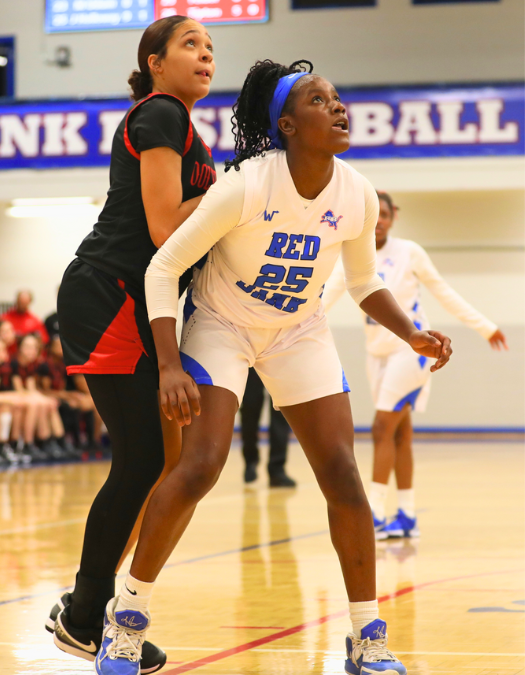 Two students play basketball