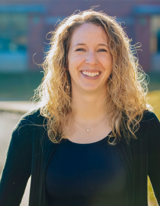 A woman smiles for a photo