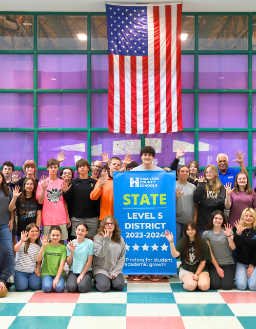 Students pose for a banner presentation photo