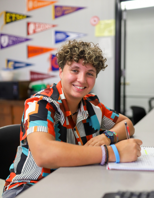 A student smiles for a photo