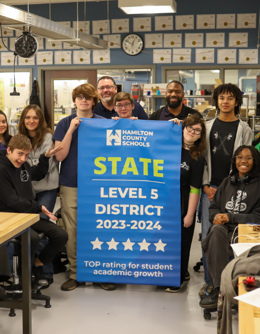 Students pose for a banner presentation photo