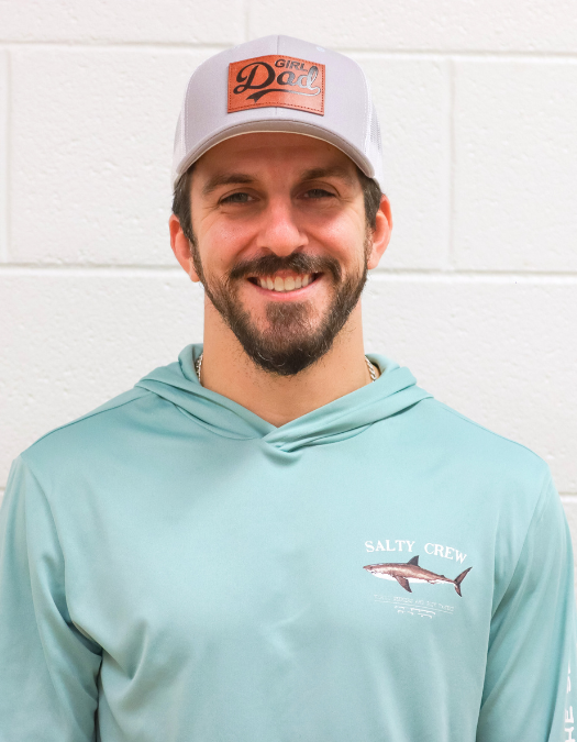 A teacher poses for a photo