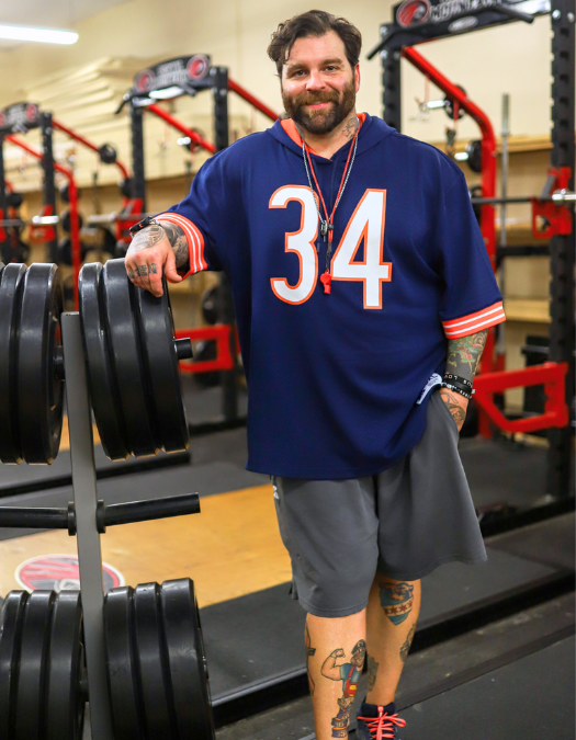 A teacher smiles for a photo