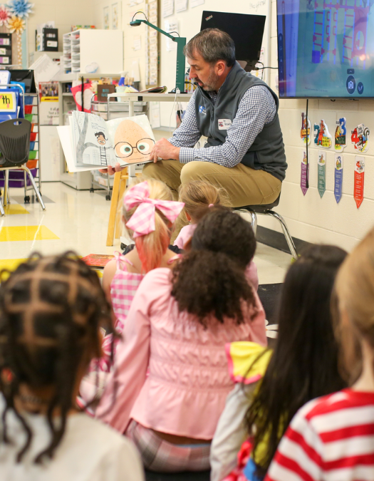Dr. Robertson reads to a class