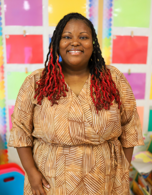 A teacher poses for a photo