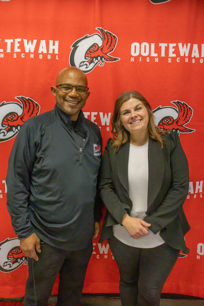 OHS 9.11.24-19 career counselor, staff , teachers, pose in front of ooltewah backdrop