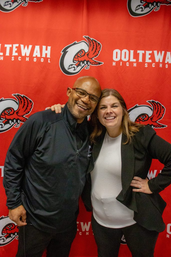 OHS 9.11.24-22 career counselor, staff , teachers, pose in front of ooltewah backdrop