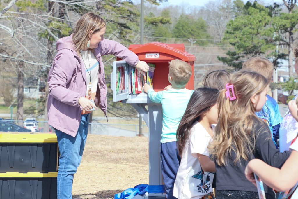 Read Across America Edited-4 A teacher helps a student get a book