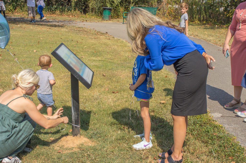 Storybook Trail 8.29.24-11 A group walks outside