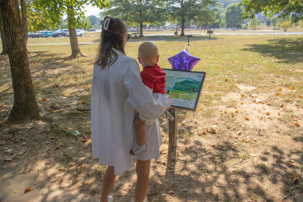 Storybook Trail 8.29.24-15 A family reads