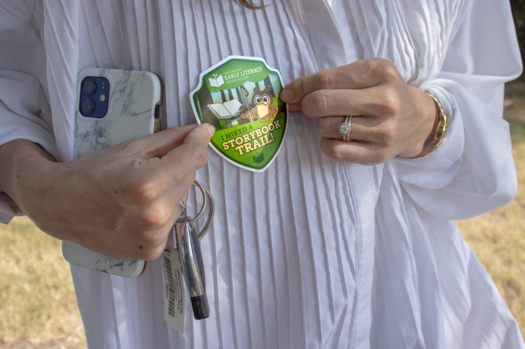 Storybook Trail 8.29.24-8 A person holds a sticker