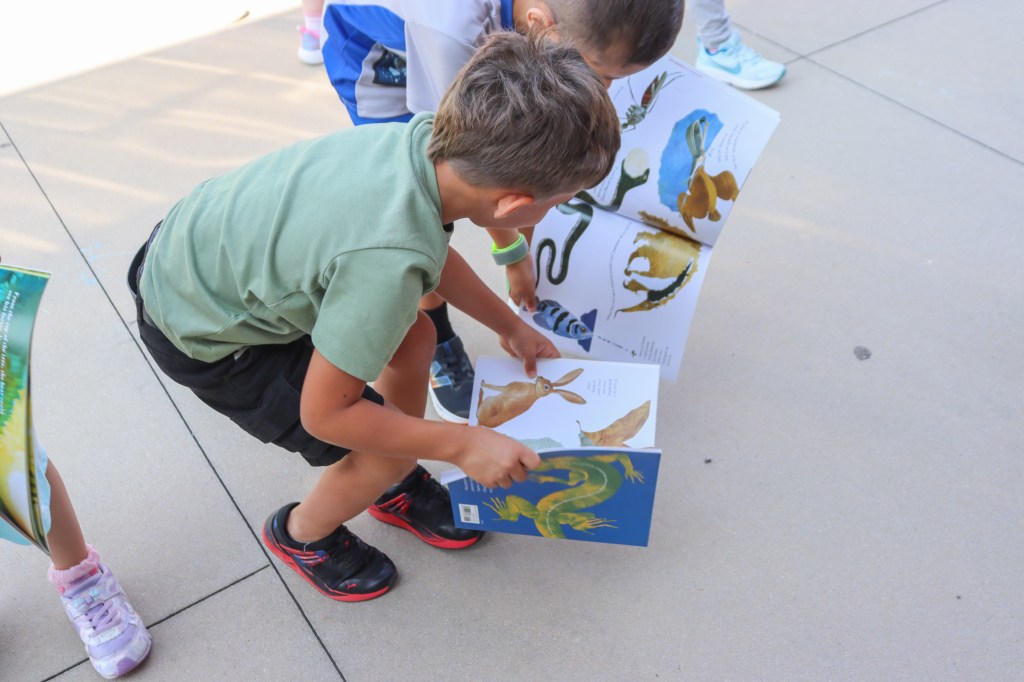 Book Bus Summer Reach MVE-18 student reading book