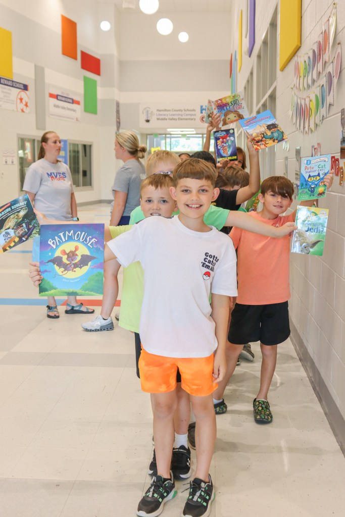 Book Bus Summer Reach MVE-21 students holding books
