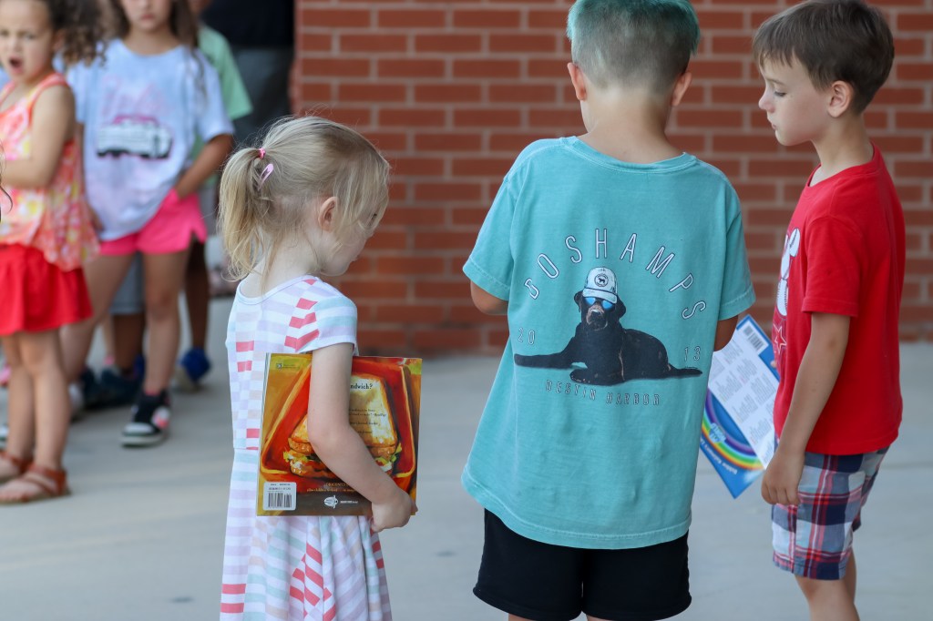 Book Bus Summer Reach MVE-5 students looking at book