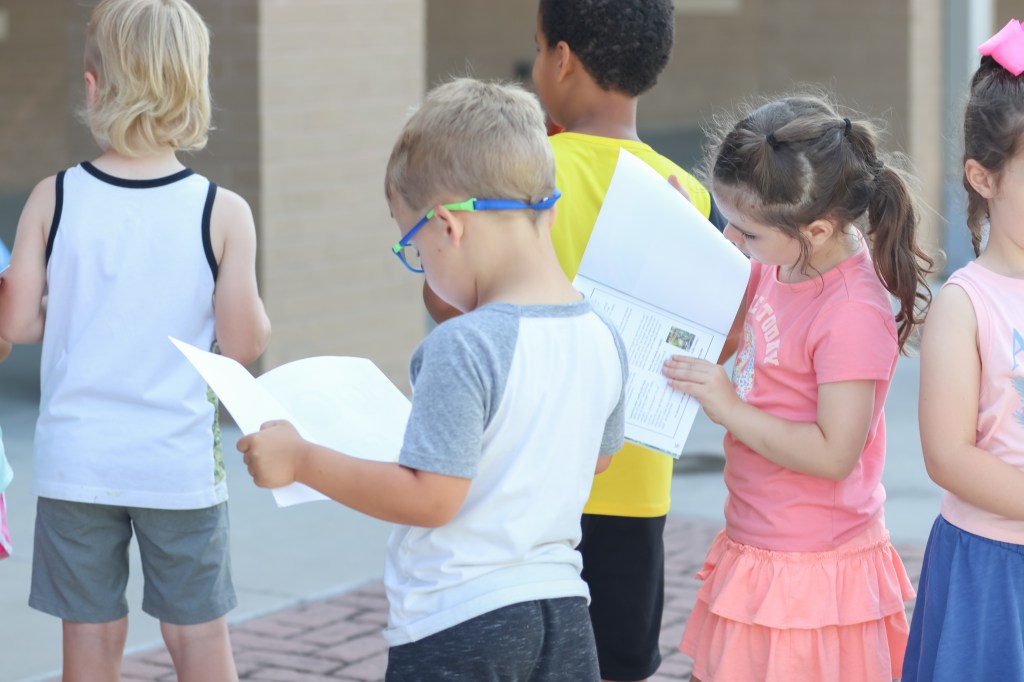 Book Bus Summer Reach MVE-6 student reading book