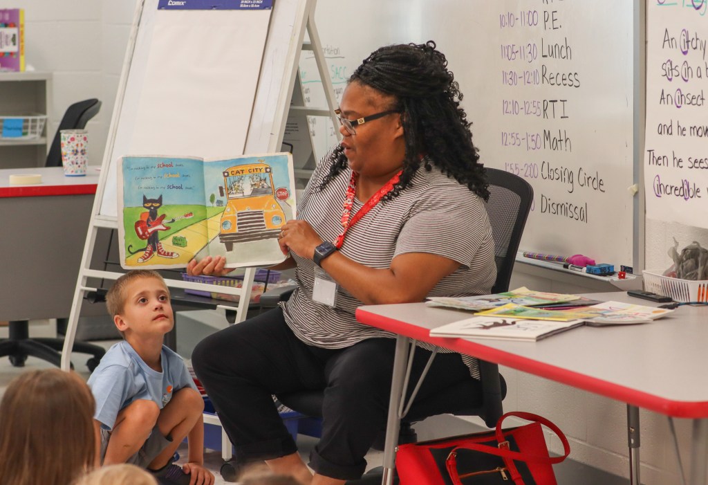 Book Bus Summer Reach MVE teacher reading book to elementary students
